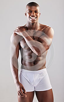 Big boys dont cry. Studio portrait of a muscular young man posing against a grey background.