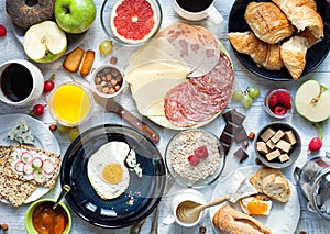 Big breakfast on the white rustic table.