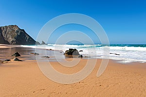 Big breaking Ocean wave on a sandy beach