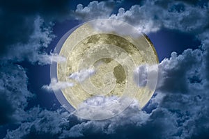 Big bright and shining full moon somewhat hidden behind clouds against a dark night sky. Fantasy illustration.