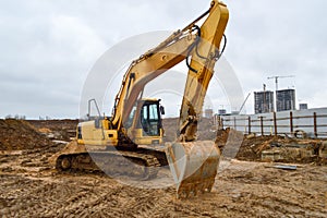 Big bright yellow powerful industrial heavy excavator tractor, bulldozer, specialized construction equipment for road repair