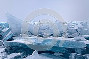 Big broken figured ice floes on hummocks field