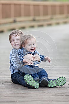 Big brother holding little brother in lap