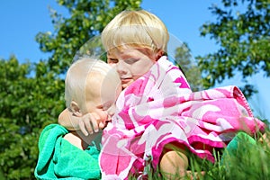 Big Brother Hugging Baby Outside in Beach Towels