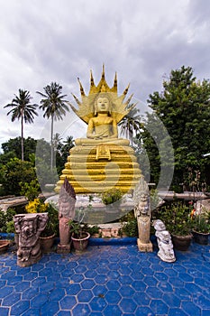 Big Buddha with a naga over His head in Thai temple