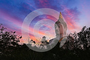 Big Buddha statue head with sunrise sky