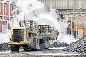 The big bulldozer and industrial pollution. Pollution is the introduction of contaminants into the natural environment that cause