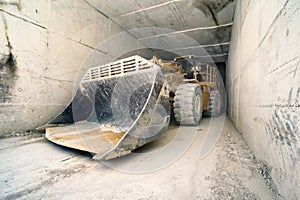 Big bulldozer in marble tunnel, Carrara, Italy