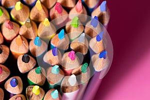 Big bunch of colorful pencils on pink background. Education, back to school concept with copy space
