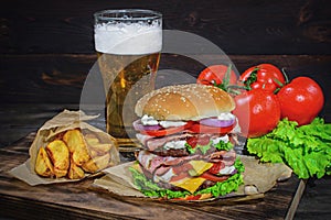 Big Burger and light beer on a wooden table