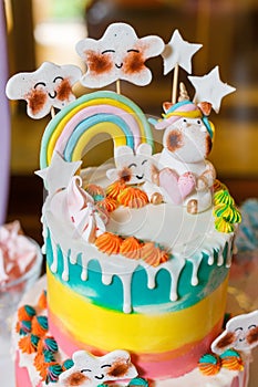 Big cake on the unicorn and rainbow theme. Sweets for children with fantasy style