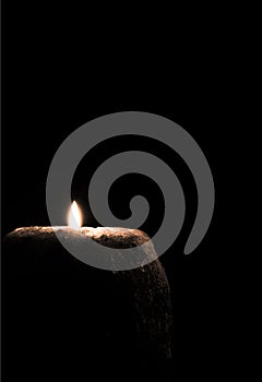 Candle burning in dark