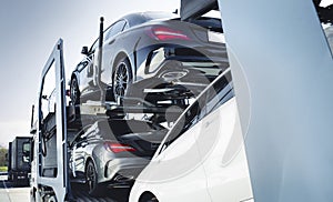 Big car carrier truck of new luxury sport  german cars  delivery to dealership . truck of new powerful  new vehicles. Car