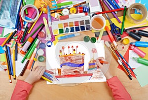 Big cartoon birthday cake child drawing, top view hands with pencil painting picture on paper, artwork workplace