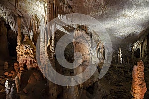 Big cavern with stalactites, stalagmites and stalagnates in Postojna cave, Slovenia, Europe