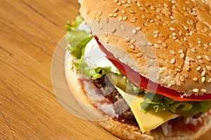 Big Cheeseburger Close up on Wooden Table