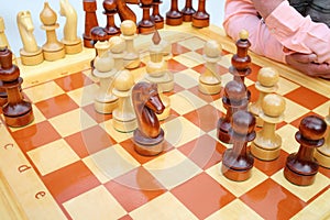 Big chessboard with black and white wood pawns photo