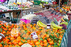 Big choice of fresh fruits and vegetables on market counter