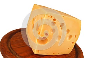 Big chunk of yellow cheese on wood