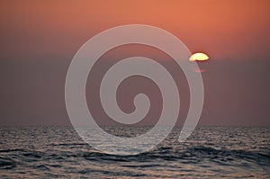 Big circle beautiful sunset on Bali sea in the evening