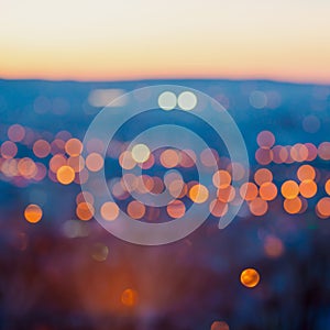 Big city lights in the twilight evening with blurring background