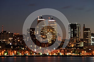 Big city at night. Beautiful modern buildings, skyscrapers and towers are reflected in Dnipro river evening, Ukraine. Dnepr