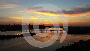 Big city scape with huge river and evening sunset sky.