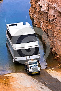 Big classic semi truck take the bid boat from lake