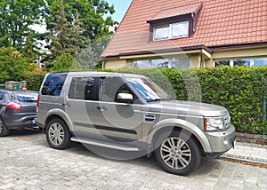 Big classic silver grey British 4WD car Landrover Discovery LR3 third generation right side and front view photo