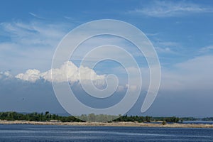 Big cloud on the horizon over the river