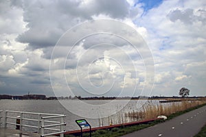 Big clouds over the river Rotte at the Eendragtspolder i