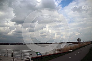 Big clouds over the river Rotte at the Eendragtspolder in Zevenhuizen, the Netherlands