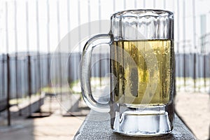 Big cold beer mug full of beer.