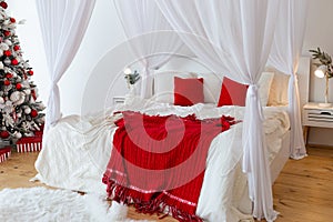 Big comfortable bed with clean linen, red pillows