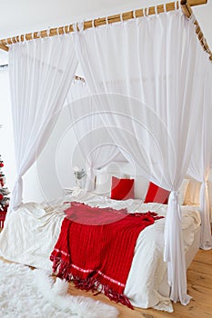 Big comfortable bed with clean linen, red pillows