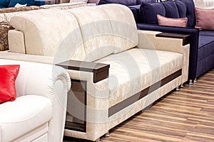 Big comfortable beige sofa in the luxury furniture store.