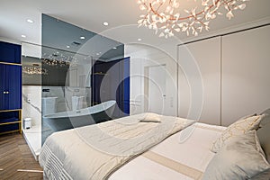 Big comfortable double bed in elegant classic bedroom