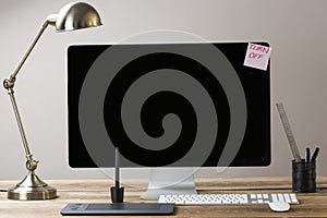 Big computer screen with stationary items