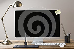 Big computer screen with stationary items