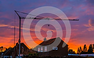 Big construction crane during sunset, building site of a house in the village of Rucphen, Architecture of the netherlands