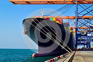 Big container vessel berthing at port prepare for discharging on a shinning day