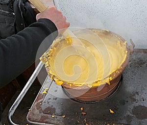 big copper cauldron with yellow POLENTA a typical dish of Northern Italy