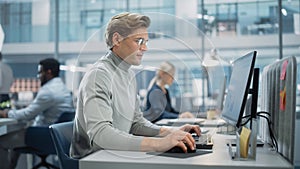 In Big Corporate Office: Portrait of Confident Handsome Manager in Grey Turtleneck Using Computer,