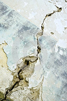 Big crack on blue wall of old building, abstract image of diagonal crack, detail. Consequences of earthquake. Copy space.