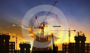 Big crane and building construction against beautiful dusky sky photo