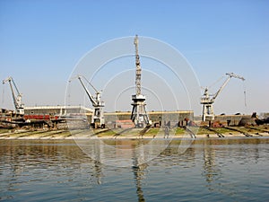 Big Cranes in a shipyard with rails next to water