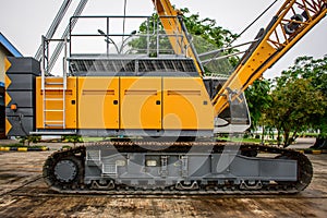 side view of crawler crane, counterweights, big chain and arms photo