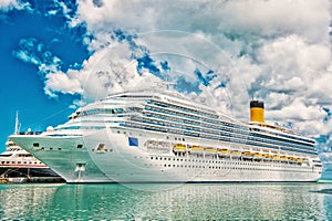 Big cruise ship. Large luxury cruise ship on sea water and cloudy sky background docked at port of st.Johns, Antigua