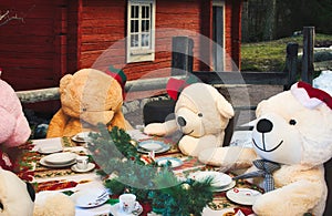 Big cuddly teddy bears in the woods having Christmas lunch