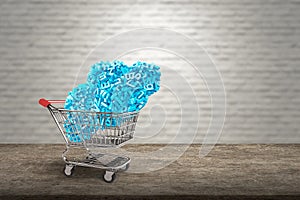 Big data. Blue characters cloud in shopping cart on desk